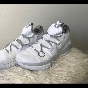 White and grey Kobe Bryant sneakers.
